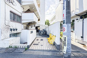 平坦なタイル敷きのアプローチが広がるマンションのエントランス前です！奥には駐輪スペースも確保されており、自転車での通勤や日々のちょっとしたお買い物時にもスムーズに出入りができて大変便利です♪